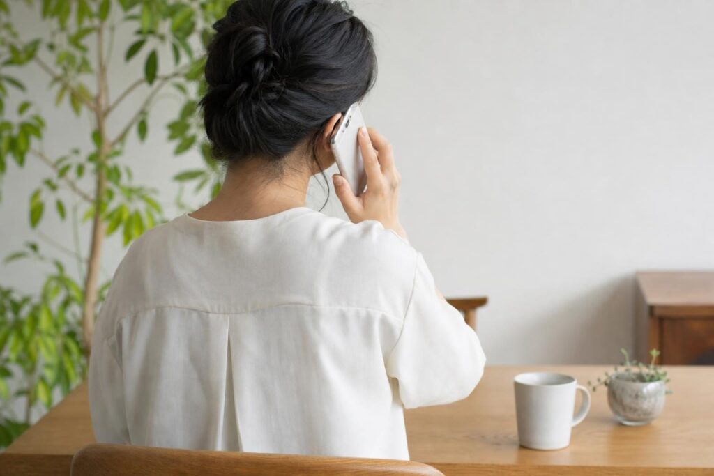 電話で相談する後ろ姿の様子
