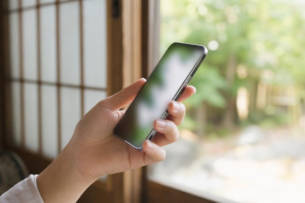 スマートフォン画面を確認する手元のクローズアップ