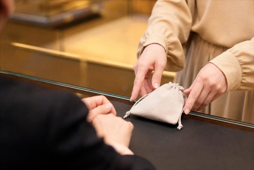 買取店のカウンターに品物を置く手元